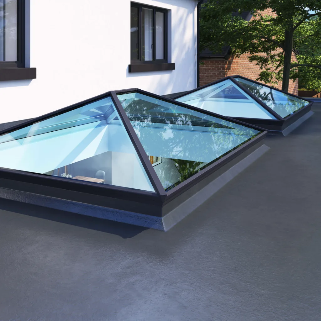 Close-up of two anthracite grey framed Korniche Roof Lanterns with a subtle blue hue in the glass, installed on a flat roof.