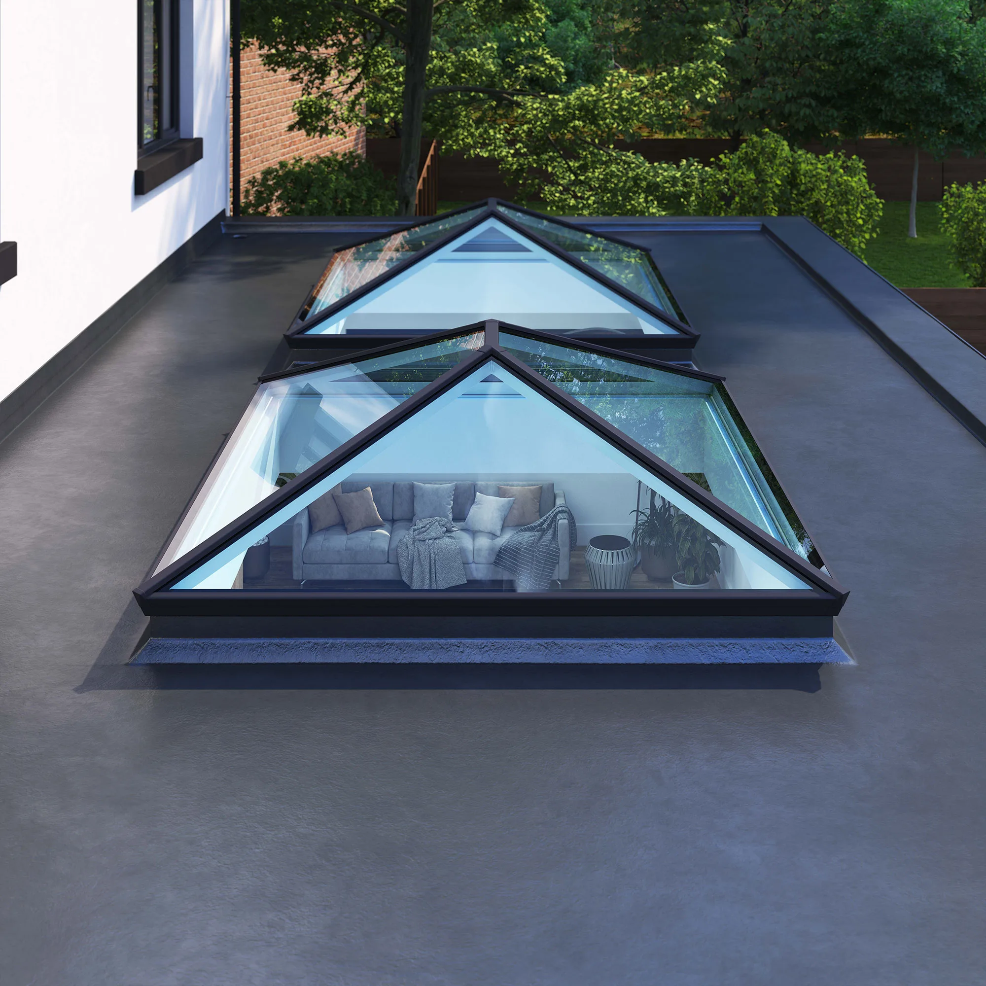 Elevated view of two Korniche Roof Lanterns installed on a flat roof, showcasing their sleek design and the light-filled interior below.