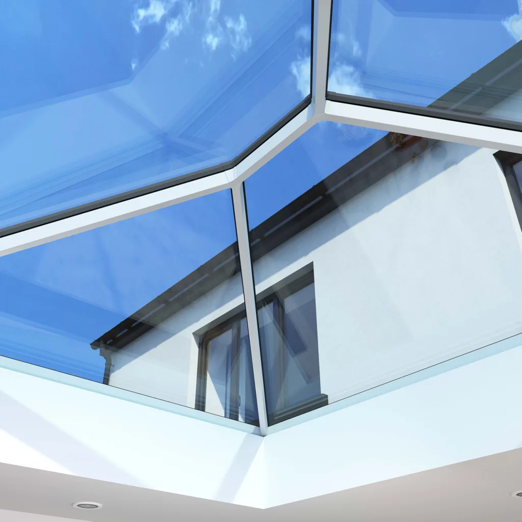 Close-up interior view of a Korniche Roof Lantern featuring a slim white internal frame and anthracite grey external frame, showcasing maximum daylight and blue sky.