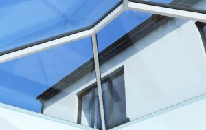 Close-up interior view of a Korniche Roof Lantern featuring a slim white internal frame and anthracite grey external frame, showcasing maximum daylight and blue sky.