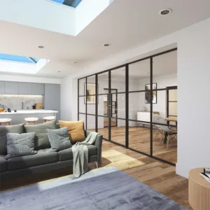 Korniche glass partition system creating a sleek and open-plan interior in a home in Stockton-on-Tees, England. The black framed glass doors and sidelights divide a dining area with a wooden table and chairs from a living room featuring a grey sofa and natural light.