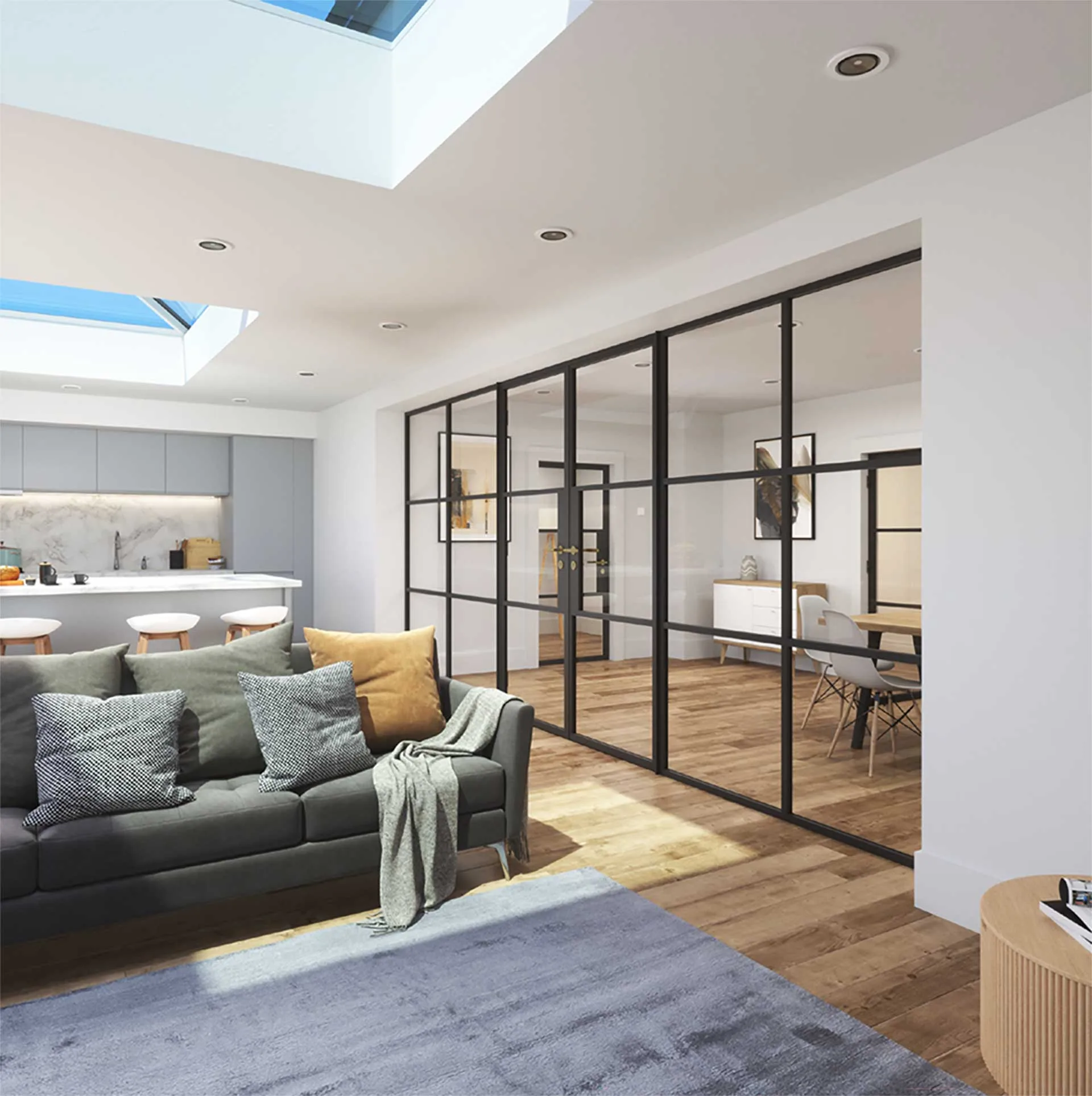 Korniche glass partition system creating a sleek and open-plan interior in a home in Stockton-on-Tees, England. The black framed glass doors and sidelights divide a dining area with a wooden table and chairs from a living room featuring a grey sofa and natural light.