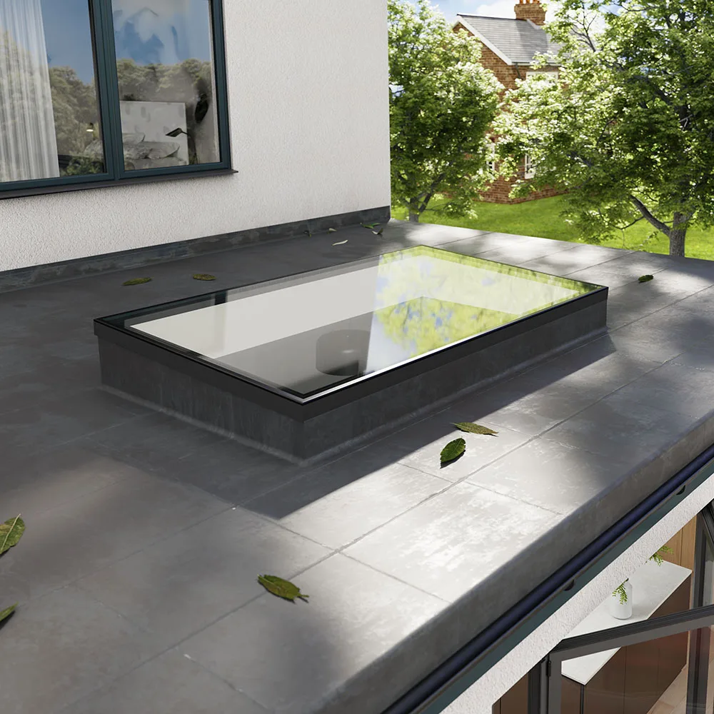 Korniche Flat Glass rooflight installed on a contemporary flat roof, blending seamlessly with the modern home exterior and surrounding garden.