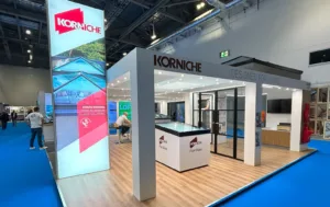 The full Korniche exhibition stand at the Homebuilding Show, displaying the Roof Lantern, Flat Glass, and Glass Partition with the