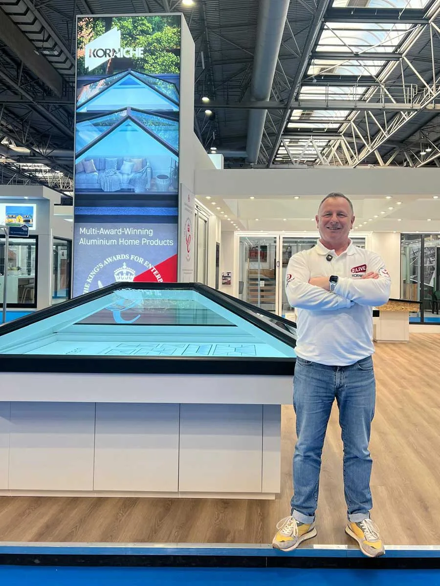Mark Millar standing beside Korniche roof lantern at NEC show
