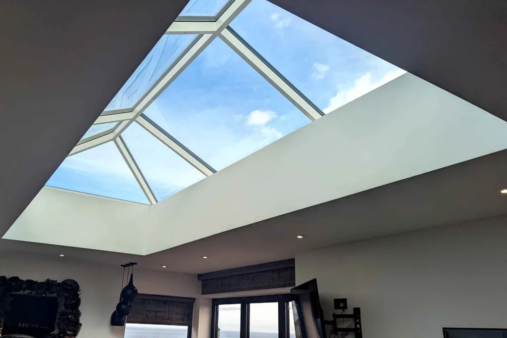 Close-up interior angle of a Korniche aluminum roof lantern structure and blue sky